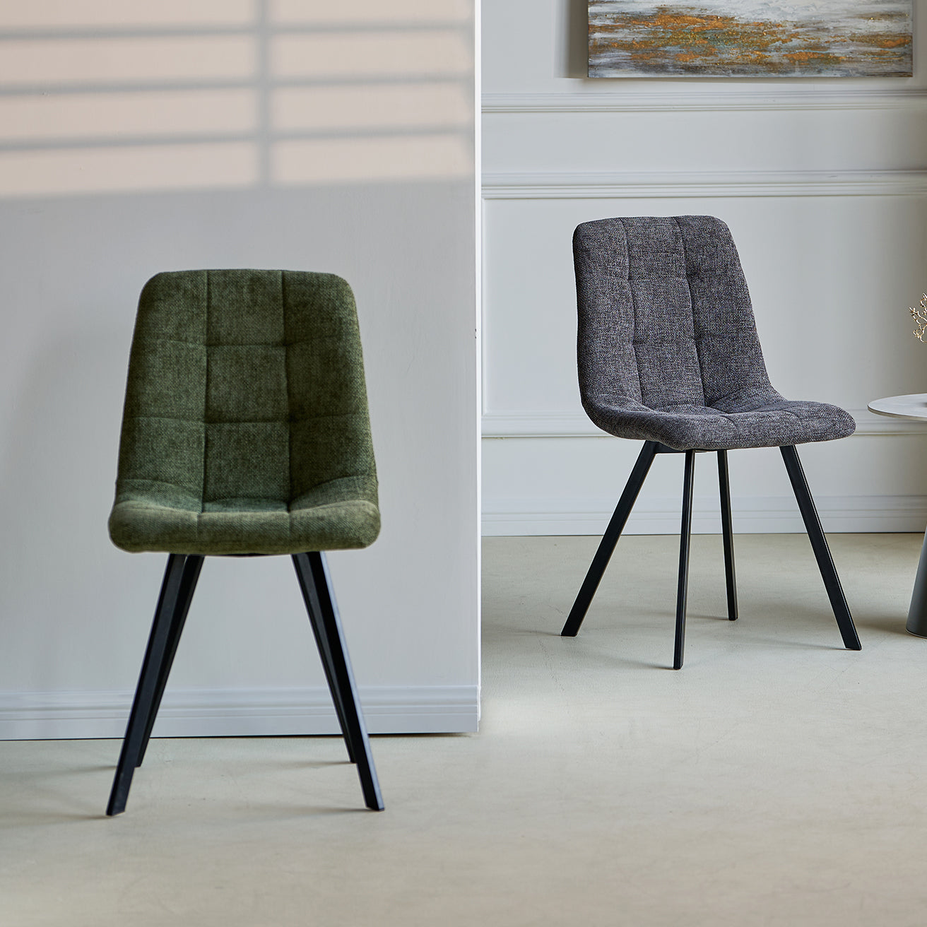 Set of four Aoife upholstered dining chairs around a contemporary table in a stylish dining room setting
