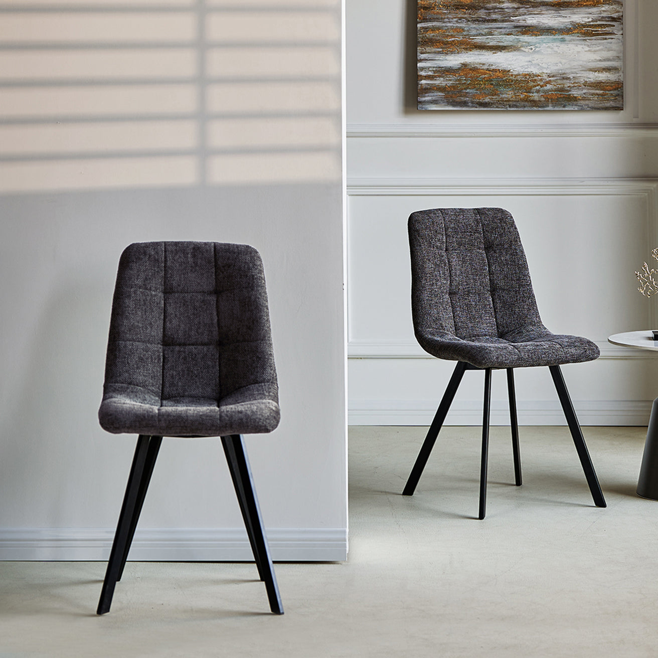 Pair of Aoife contemporary dining chairs in neutral fabric with slim black metal legs, perfect for modern kitchens and dining rooms