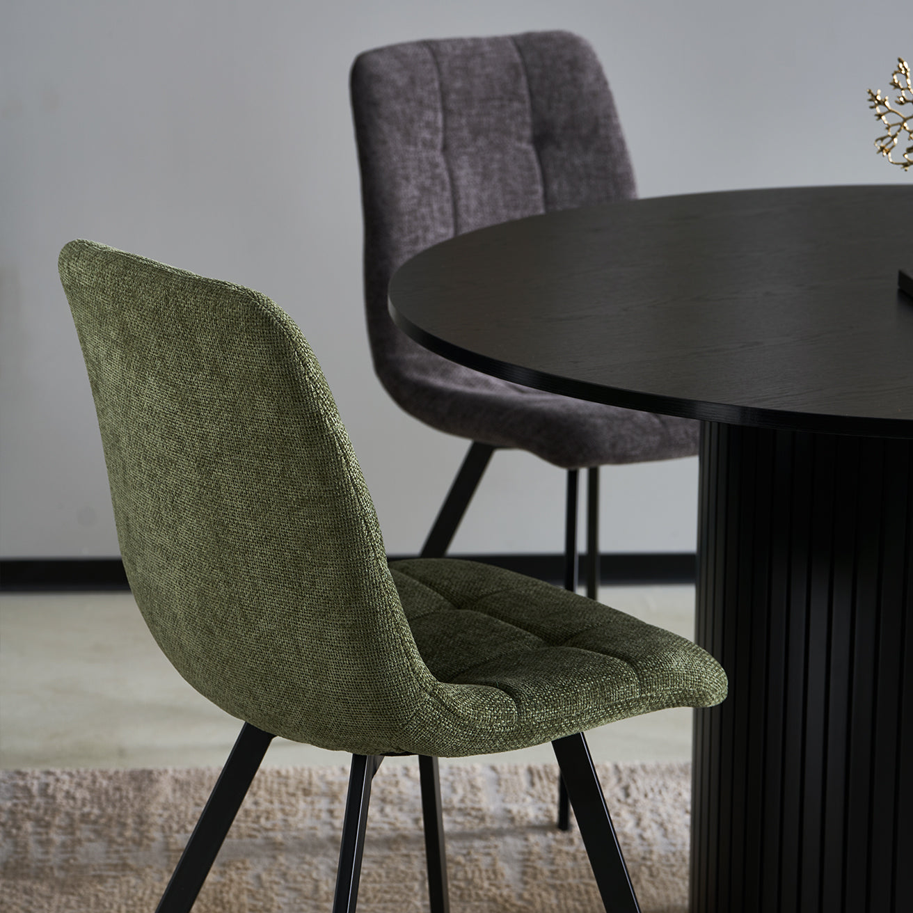 Black powder-coated metal legs on Aoife dining chairs providing stable support with scratch-resistant floor protectors